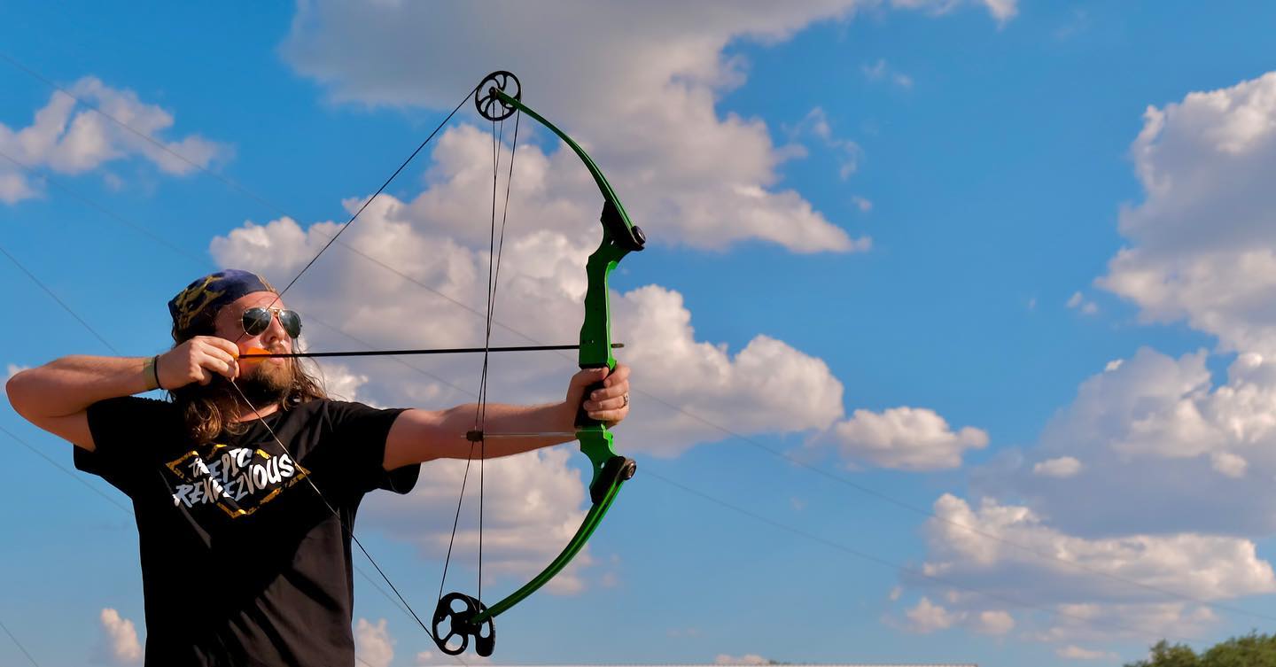 http://Adult%20Summer%20Camp%20Guy%20Shooting%20bow%20and%20arrow